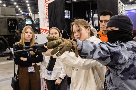 Visitors seen during the training with a laser shooting simulator for a Kalashnikov assault rifle at the exhibition of advanced technologies for ensuring the security of individuals, society and the state "Expotechnoguard" at the Expoforum convention and exhibition center in St. Petersburg.