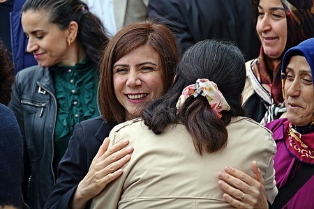 DEM Party member Ayse Serra Bucak Kucuk, who was elected Diyarbakir Metropolitan Municipality Co-Mayor, is seen being congratulated by a party member. Ayse Serra Bucak Kucuk and Dogan Hatun from the People's Equality and Democracy Party (DEM Party), who won the Metropolitan Municipality Co-Mayorship of Diyarbakir, the largest of the Kurdish cities in Turkey, officially started their duties today by receiving their certificates of election from the Provincial Election Board. Thus, the Kurds took back the Diyarbakır municipality from the trustees after 8 years. Ayse Serra Bucak Kucuk, who was elected Co-Mayor of Diyarbakir Metropolitan Municipality, lived in Bremen and Cologne, Germany, between 1995-2006 and graduated from the German Language and Literature and Pedagogy departments of the University of Cologne. Bucak's father, Lawyer Serhat Bucak, is a famous Kurdish politician who is banned from politics in Turkey and has been living in Germany for nearly 40 years.