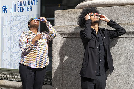 People watch a partial solar eclipse on 5th Avenue on April 8, 2024 in New York City. With the first solar eclipse to pass through North America in seven years, New York City was not in the path of totality, with only 90% of the sun covered by the moon; the next eclipse visible in the United States will be in 2044.