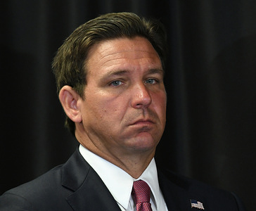 Florida Gov. Ron DeSantis listens to a speaker at a press conference in Sanford, Florida where he signed legislation to increase penalties on individuals who expose law enforcement officers to fentanyl, and to bring awareness to life-saving measures for someone experiencing an opioid overdose.