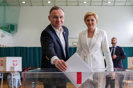 President Andrzej Duda of Poland (L) and Agata Kornhauser-Duda of Poland (R) seen casting their votes at the electoral commission during the Local Government Elections in Poland 2024.