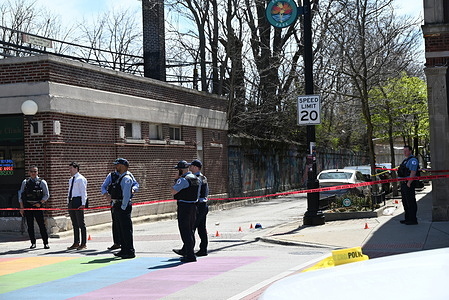 Police converge on a crime scene, where two people were shot with one of them being killed. Two people shot, one killed in broad daylight in Chicago, Illinois, United States. A 41-year-old male and a 33-year-old male were outside at the 6900 block of N. Glenwood Avenue Tuesday morning at approximately 11:16 a.m. when an unknown offender approached and began to fire shots in their direction. The 41-year-old male victim sustained a gunshot wound to his back and was transported to the hospital, in good condition and the 33-year-old male victim sustained a gunshot wound to his back and was transported to the hospital, where he was pronounced dead. No one is in custody and Area Detectives are investigating.