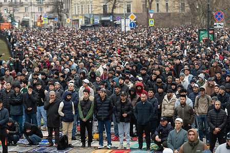 Muslims pray on the street during the celebration of Eid al-Fitr near the Cathedral Mosque in St. Petersburg. Thousands of people have gathered for the festive prayers in mosques and prayer rooms in St. Petersburg and other cities and towns around the world.