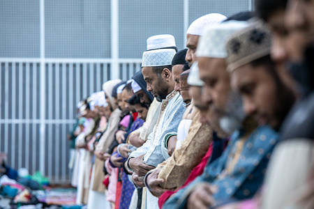 A group of men pray during the prayer for the end of the Muslim holiday of Ramadan in Madrid. Part of the Muslim community based in the LavapiÈs neighborhood of Madrid has gathered for another year at the municipal sports courts of the Parque del Casino de la Reina for the Celebration of Eid El-Fitr (end of Ramadan).