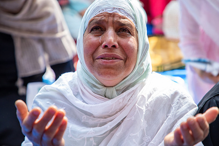 A Kashmiri woman seen offering Eid-Al-Fitr prayers outside a mosque in Srinagar. Hundreds of Kashmiri Muslims celebrate Eid-Al-Fitr, marking the end of the holy fasting month of Ramadan. To control the crowd, Indian authorities limit entry to Kashmir's historic Grand Mosque, or Jamia Masjid, for Eid-Al-Fitr prayers in downtown Srinagar for the fifth consecutive year. Despite this restriction, some faithful gather outside the grand mosque to offer their prayers.