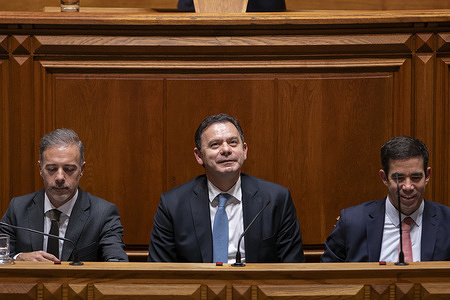 The Prime Minister of Portugal Luis Montenegro (C) flanked by the Minister of Parliamentary Affairs Pedro Duarte (L) and the Minister of the Presidency Antonio Leitao Amaro (R) seen during the debate on the Government's program. The XXIV Constitutional Government of Portugal, led by Prime Minister Luis Montenegro, presented the government program. The document was debated in the Portuguese parliament.