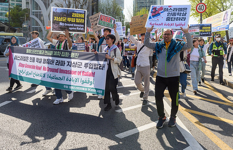 Pro-Palestinian supporters hold a banner and placards during a protest in downtown Seoul. Pro-Palestinian supporters marched in downtown Seoul calling for the end of Genocide Now! and No Ground Invasion of Rafah!.