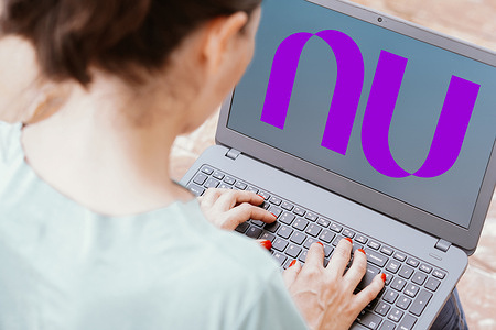 In this photo illustration, the Nubank logo is seen displayed on a laptop screen.