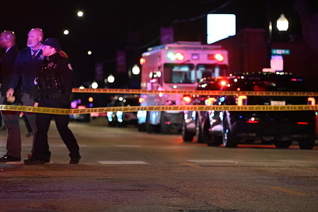 Chicago Police rush to the scene of a mass shooting in the area of West 52nd Street. Eight people were shot including five adults and three children in the area of West 52nd Street in Chicago. Adults that were shot vary in age from 19 to 40 years old. A 1-year-old male Hispanic was shot multiple times and is in critical condition, a 7-year-old male Hispanic was shot multiple times and is in critical condition, a 7-year-old female Hispanic was shot in the head and was pronounced dead. No suspects are in custody at this time and the shooting appears to be gang related.