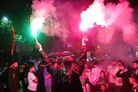 An Amedspor fan is seen carrying red flares during the victory celebrations. Hundreds of people celebrated as Amedspor, competing in the Turkish Football Federation 2nd League Red Group, came close to the championship by securing a 1-0 victory in an away match against Kastamonuspor this week. With three matches remaining in the league, Amedspor will play two of them at home.
