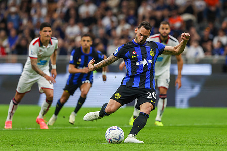 Hakan Calhanoglu of FC Internazionale scores a penalty during the Serie A 2023/24 football match between FC Internazionale and Cagliari Calcio at Giuseppe Meazza Stadium. Final score; Inter 2:2 Cagliari.
