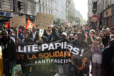 Protesters hold a banner and placards during the demonstration in support of the young migrants that occupy the Maison des Métallos. Hundreds of people demonstrated from the Place de Republique to the House of Metalworkers, in Paris, to show support for the young migrants occupying the Maison des Métallos. Under the threat of the Darmanin law, the “social cleansing” generated by the Olympic Games, and in the absence of any housing supply, more than 250 unaccompanied minors are occupying, since 6th April, the Maison des Métallos, located in the 11th arrondissement of Paris.
