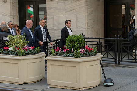 NYSE Traders make their way through security while Pro-Palestine demonstrators rally outside in the Financial District of New York City. Organizers joined other participating cities in creating an economic blockage in solidarity with Palestine.