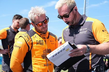Sam Bird (L) of Neom McLaren Formula E team with his team at the Starting Grid for Round 7 race of ABB Formula E World Championship Season 10 in Misano.