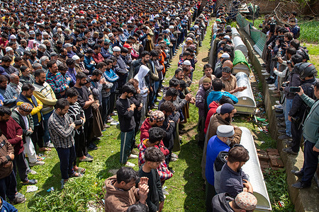 Relatives and residents offer prayers during a funeral for victims who died after a boat capsized in the Jhelum River. At least six people died and 19 are missing after the boat capsized in the Jhelum River near Srinagar, with most of the passengers being children on their way to school. Rescuers and the Indian Army's marine commandos are scrambling to find survivors as hundreds worried and mourning. Heavy rains fell over the Himalayan region in the past few days, led to higher water levels in the river which caused the tragedy.