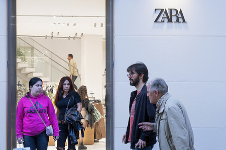 Shoppers are seen the Spanish multinational clothing design retail company by Inditex, Zara, store in Spain.