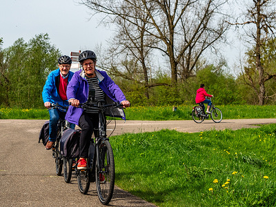 People are seen cycling over one of the dikes.