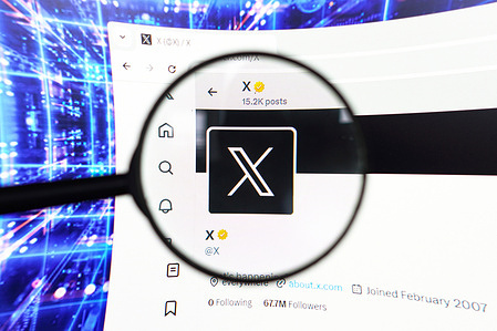 In this photo illustration, the X (Twitter) logo seen displayed on a computer screen through a magnifying glass.