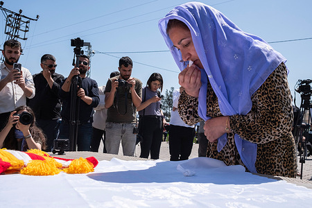 A woman performs religious rituals during the Red Wednesday. The Carsema Sor Feast, also known as "The Red Wednesday,"rebirth, the onset of auspicious times, the commencement of spring, or absolute goodness for the Yazidis, and was celebrated in the Viransehir district of Sanliurfa. Carsema Sor (The Red Wednesday), commonly referred to as the "New Year of the Yazidis," is observed annually on the first Wednesday after April 13th. Numerous Yazidi citizens participated in the Yazidi New Year festivities, which were held for the first time in many years in Viransehir's Burc Village.