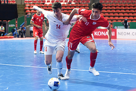 Behrooz Behrooz Azimihematabadi (L) of IR Iran and Mohammad Moradi (R) of Afghanistan seen in action during the AFC Futsal Asian Cup 2024 Group D match between IR Iran and Afghanistan at the Indoor Stadium Huamark in Bangkok. Final score; IR Iran 3 : 1 Afghanistan.