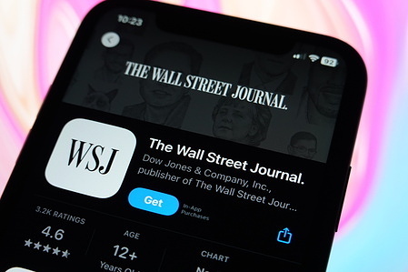 In this photo illustration, the Wall Street Journal logo is displayed in the Apple Store on an iPhone.