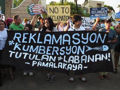 Protesters hold a banner and placards expressing their opinion during the demonstration. Groups united under the banner "Defend Manila Bay", gathered in Navotas City to mark the Earth Day. The various groups are pushing for the conservation of Manila Bay and are demanding President Marcos Jr. to cease all reclamation activities currently destroying the bay.