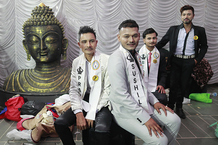 Contestants watch the show backstage via a television screen before their show in front of the judges and audiences during the first edition of Mister Gay Nepal in Kathmandu.