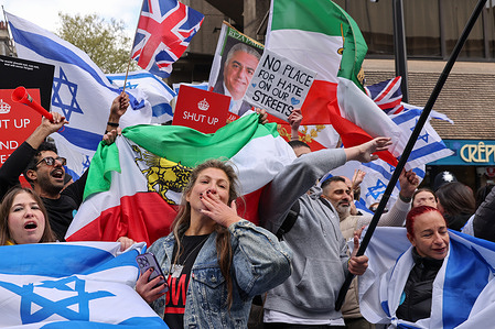 Pro-Israel supporters wave flags as they stage a counter protest during a pro-Palestine demonstration outside Barclays bank on Tottenham Court Road in London as the Israel - Hamas war continues.