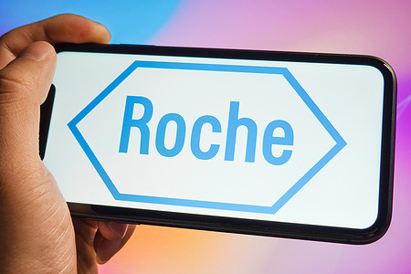 In this photo illustration, a Roche logo is displayed on the screen of an iPhone.