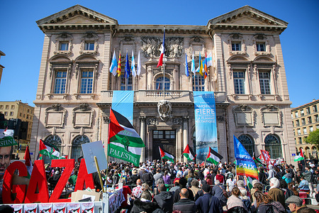 Protesters hold Palestinian flags and a banner during the march. A thousand people gathered and marched from Place d'Aix to Marseille city hall in solidarity with the Palestinian victims of the war between Israel and Hamas and to demand an end to exports of arms to Israel.