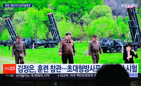 South Korea's 24-hour Yonhapnews TV shows North Korean leader Kim Jong un (C) inspecting a tactical drill simulating a nuclear counterattack by North Korean super-large multiple rocket units on a TV at Yongsan Railroad Station in Seoul. North Korea has conducted a tactical drill simulating a nuclear counterattack involving super-large multiple rocket launchers, state media said on April 23, a day after South Korea said that North fired short-range missiles into the East Sea.
North Korean leader Kim Jong un guided the drill held on April 22 to operate super-large multiple rocket units that will have an "important role in substantially strengthening the prompt counterattack capacity of the state nuclear force," the Korean Central News Agency said.
"This drill was conducted at a time when the military confrontation of the enemy against North Korea is extremely provocative and aggressive, and it is a clear warning signal to the enemy," the Korean Central News Agency said.