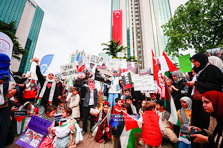 Turkish and Arab children hold flags and placards in front of the Israeli Embassy in Istanbul demanding an end to the war and the killing of Gaza children on the occasion of Children's Day in Turkey. April 23 is celebrated as National Sovereignty and Children's Day in Turkey, emphasizing the importance of children and their rights in the country.