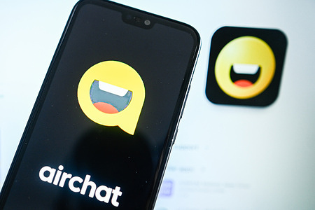 In this photo illustration the Airchat logo is displayed on a smartphone with Airchat logo in the background.