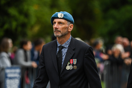 UN peace keeping forces veteran is seen marching during Anzac Day parade at Shrine of Remembrance memorial in Melbourne.
