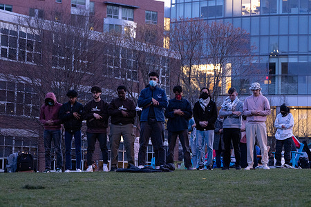 A group of pro-gaza protesters do prayer at a college encampment at Northeastern University. Students are demanding their university divest from the Israeli government and companies. Earlier in the day, Boston police in riot gear had surrounded the student chain threatening to shut their encampment down.