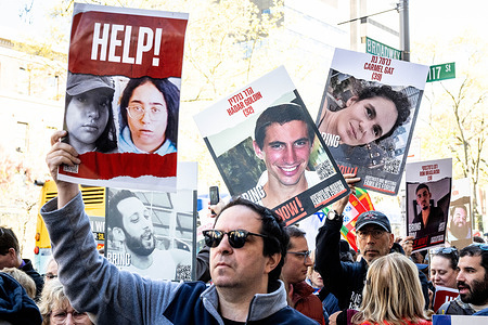 People holding signs about hostages held by Hamas in Gaza at a rally to free hostages held by Hamas in Gaza, while standing in front of Columbia University in New York City.