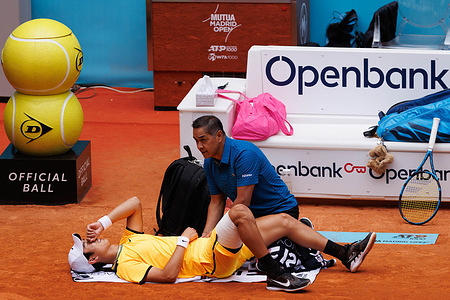 Juncheng Shang receives medical assistance during their match on Day 5 of the Mutua Madrid Open at Caja Magica Stadium. Alejandro Davidovich won 7 -5, 6-3