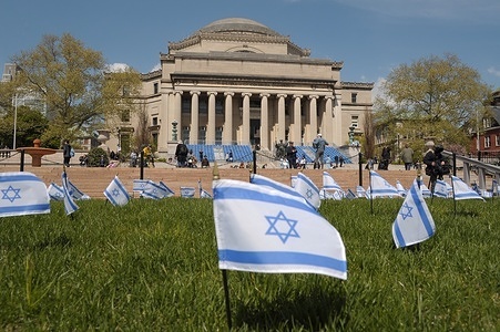 Israeli flags are seen planted in a lawn near a pro-Palestine encampment at Columbia University. Pro-Palestine demonstrators rallied on the lawn in Columbia 
University in Manhattan, New York City condemning the Israel Defense Forces' military operations in Gaza. Since last week, students and pro-Palestine activists at Columbia University have held a sit-in protest on campus, forming a "Gaza Solidarity Encampment." Encampments have been forming in other universities in New York City, as well as in campuses nationwide in support of Palestine. Negotiations are underway between student protestors at Columbia University and the school administration about the removal of the encampment. There has been increasing tension between the student protesters and the university officials regarding the use of law enforcement to disassemble the encampment. Since the war started on October 7, 2023, Gaza's health ministry said more than 34,000 people have been killed in Gaza, a territory ruled by Hamas. The death toll does not differentiate between civilians and combatants.