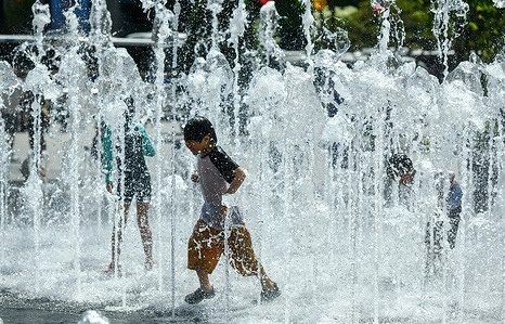 South Korean children play with water at the fountain in the high temperature afternoon at Gwanghwamun Square in Seoul. On April 27, the temperature in Seoul is up to 26 degrees Celsius.