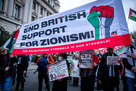 Protestors hold a large banner during the National March for Palestine Protest. The Palestine Solidarity Campaign organised a march from Parliament Square to Hyde Park, London to demand UK government stop arming Israel and call for a permanent ceasefire.
