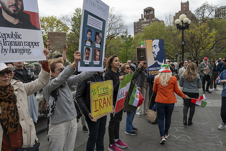 Protesters hold Iranian flags and signs calling to free Toomaj Salehi and Free Iran during a protest in solidarity with the Iranian rapper Toomaj Salehi who was sentenced to death by courts in Iran for supporting anti-government protest movement in Washington Square Park.