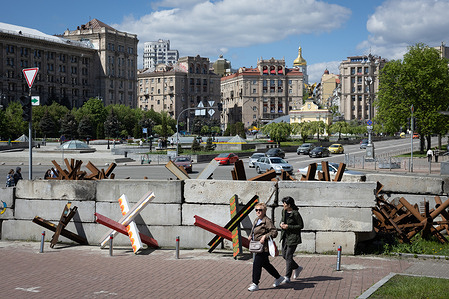 Women walk near anti-tank hedgehogs in central Kyiv. Ukrainian capital is located away from the fighting places, but the presence of war is felt in the city and affects many aspects of the life of local residents. Russian troops entered Ukrainian territory on February 2022, starting a conflict that provoked the destruction of areas and humanitarian crisis.