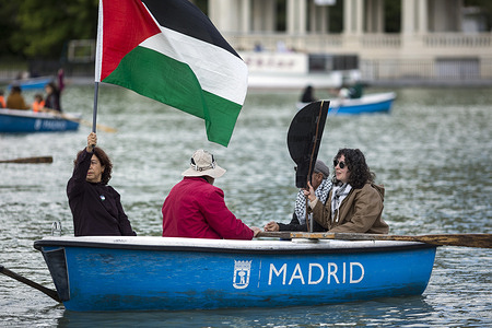 An Activist holds a Palestinian flag while on a boat during a rally on the lake in El Retiro park in Madrid, to demand an end to the genocide in the Gaza Strip and in tribute to the Freedom Flotilla that contains 5,500 tons of aid to Gaza. The Freedom Flotilla mission was postponed due to Israel's continued blockades and its pressure on the Turkish government and other states to block the trip, it remains in Istanbul with 5,500 tons of humanitarian aid for Gaza.
