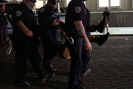 Police carry a man who has been arrested. Columbia University calls in the NYPD to “restore safety and order to our community” after Pro-Palestine protesters occupied Hamilton Hall overnight. The hall was vandalized and blockaded and all safety personnel were forced out of the building.