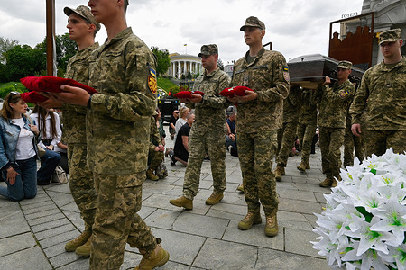 Ukrainian servicemen carry the coffin of Ukrainian soldier Eduard Khatmullin, who died in battle against the Russian troops, during a funeral ceremony at Independence Square in Kyiv.