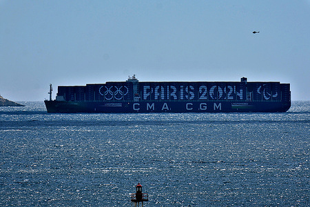 General view of the arrival of the CMA-CGM Greenland container ship, painted with color of the Paris 2024 Olympic Games, in Marseille. The container ship CMA-CGM Greenland, carrying 15,000 containers dressed in the colors of the Paris 2024 Olympic Games, will participate in the nautical parade of 1,024 ships around the Belem﻿ for the arrival of the Olympic flame in Marseille on May 8, 2024.