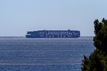 View of the CMA-CGM Greenland container ship, painted with colors of the Paris 2024 Olympic Games at the Bay of Marseille. CGM Greenland container ship seen displaying the Paris 2024 Games logo on its 15,000 containers.