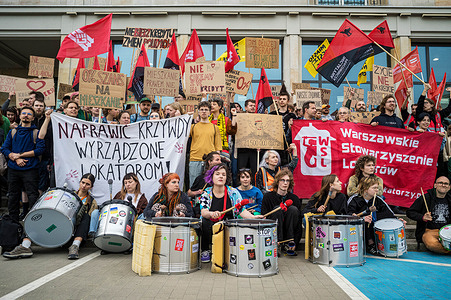 Protesters take a group photo with placards, banners, drums and flags during a demonstration. A loose coalition of Varsovian grassroots left-wing organisations staged a demonstration outside the Ministry of Development and Technology in Warsaw to protest the elites they suggest are fueling the housing crisis, and to demand money be allocated to expand the public housing stock.