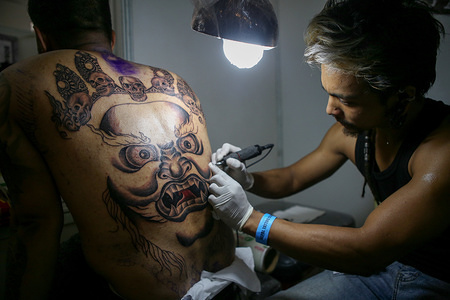 A tattoo artist seen working on a customer during the 9th International Tattoo Convention.              
Tattoo artist from Nepal and around the world attend the convention.