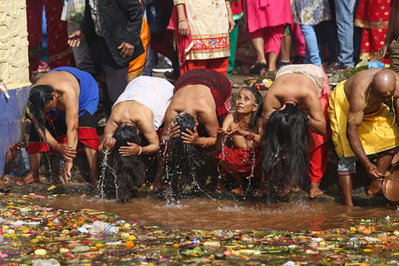 Nepalese people seen taking a holy bath at Matatritha shrine during the Mothers Day.
Nepalese, whose mothers have already passed away take a holy bath at the sacred Matatritha shrine to commemorate their departed soul of their mother and others observe Mother’s Day by showing gratitude to their mother and presenting sweets and gifts.